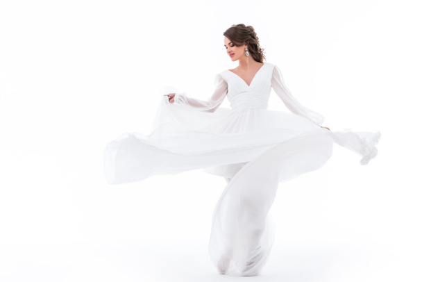 elegant bride dancing in traditional white dress, isolated on white - Photo, Image