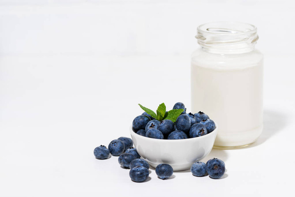 fresh blueberries and a bottle of milk - Fotó, kép