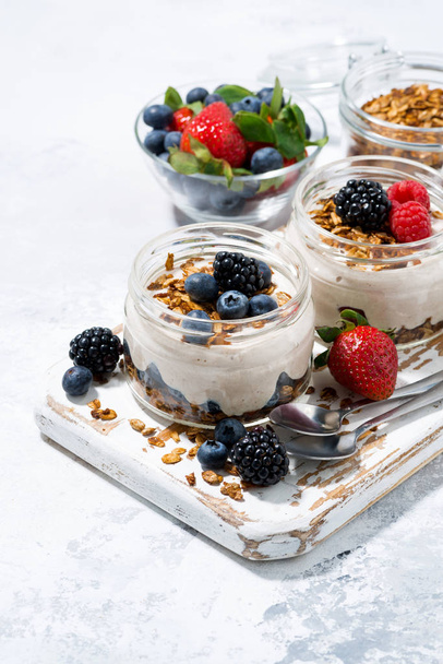 healthy creamy dessert with fresh berries, vertical top view - Фото, изображение