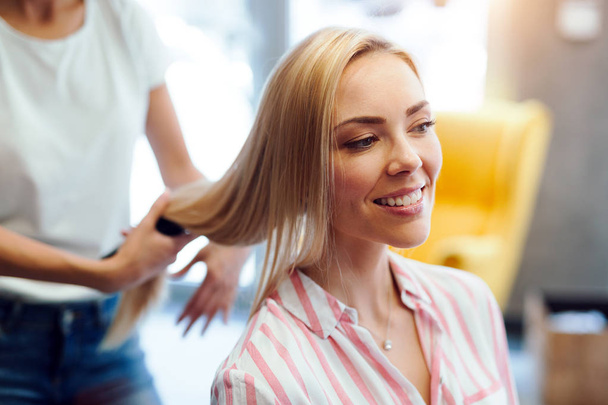 Portrait of a happy woman at the hair salon - Photo, Image