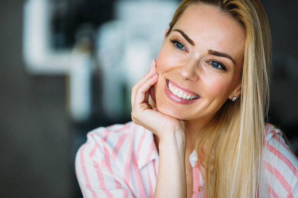 A portrait of a beautiful blonde woman smiling. - 写真・画像