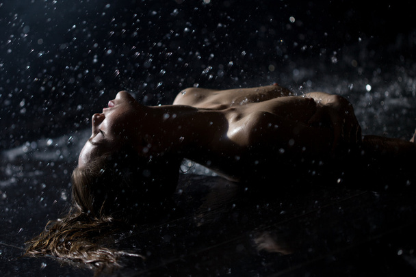 Beautiful and sexy young woman in rain - Foto, afbeelding
