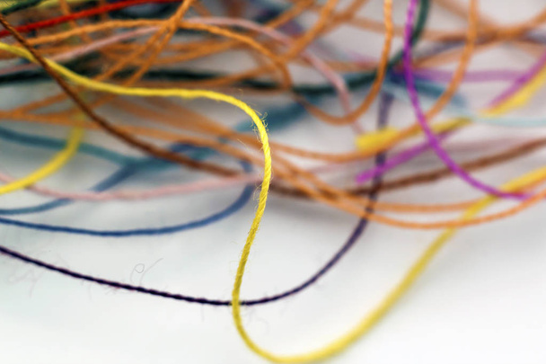 Multi-colored tangled colorful needlecraft silk thread rope. Mac - Foto, Bild