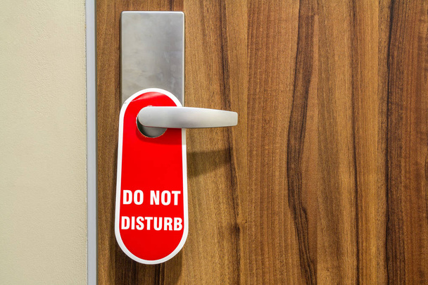 Door of hotel room with sign please do not disturb. - Photo, Image
