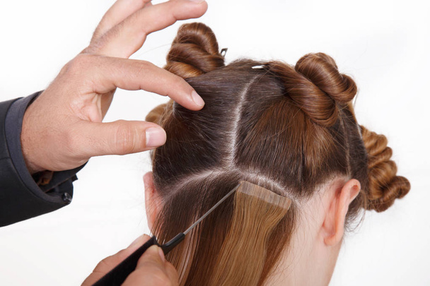 Natural Hair extensions at salon, closeup hands in hair - Foto, immagini