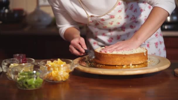 Vrouw is het kappen van een ronde gebakken billet van taart in een bakkerij - Video