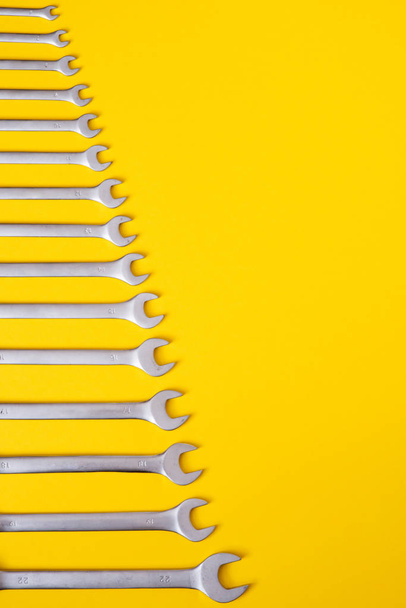 A set of wrenches on yellow background - Fotó, kép