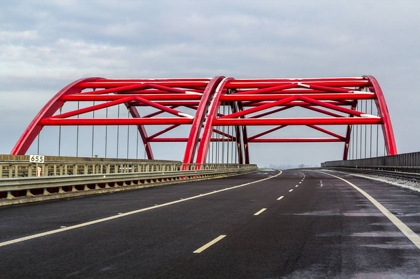 Metal frame structure of a bridge over a highway road - Foto, Bild