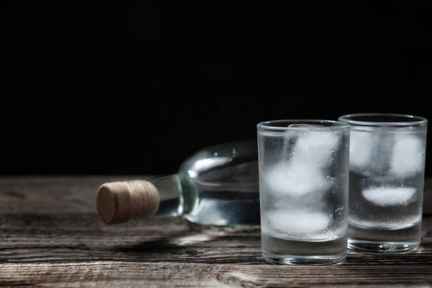 Studená vodka v záběru brýle na černém pozadí - Fotografie, Obrázek