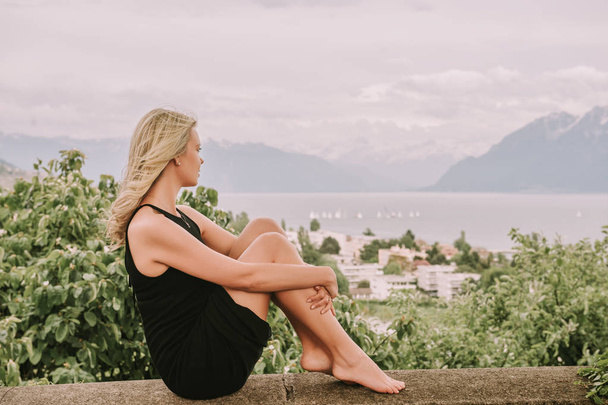 Portrait of young blond woman resting outdoors in Lavaux vineyards, Switzerland - Zdjęcie, obraz