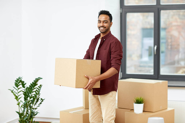 happy man with box moving to new home - 写真・画像