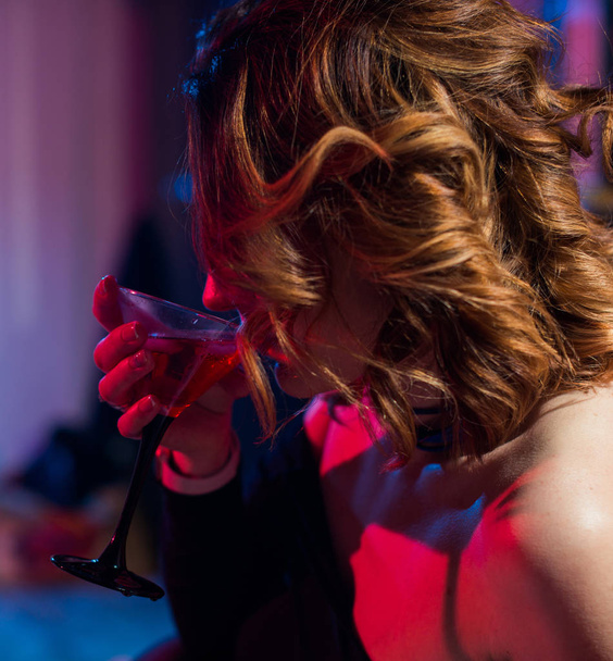 young woman drinks alcohol coctail at party time - Fotó, kép