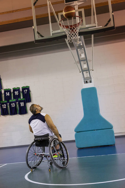 disabled sport men in action while playing indoor basketball - Foto, immagini