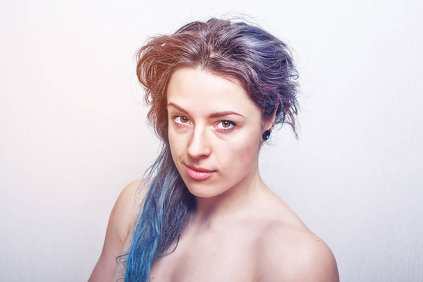 Clean portrait of a thirty year old woman with messy hair dyed in violet and turquoise colors. Color toned. - Photo, Image