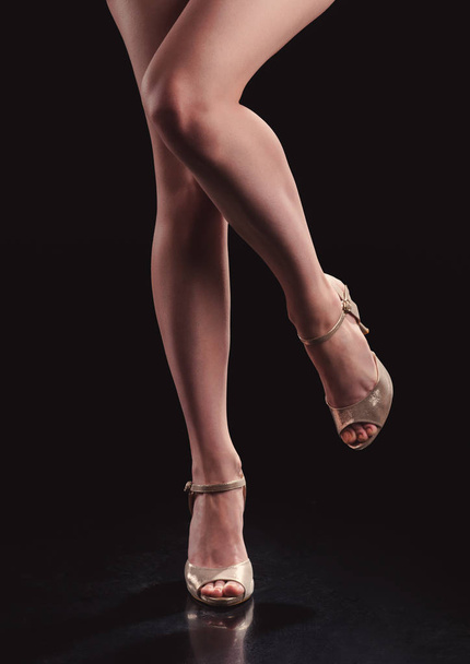 woman legs in shoes on black background - Foto, Imagem