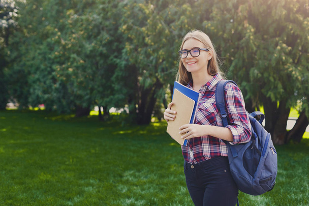 Student girl with books in park outdoors - Photo, Image