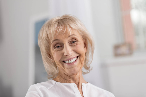 Tender mature woman smiling at camera - Photo, image