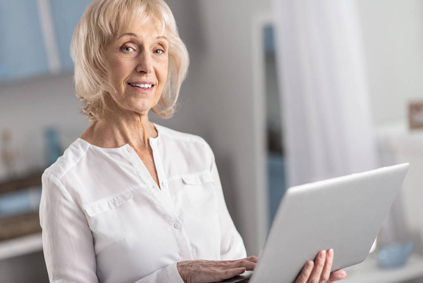 Musing mature woman studying online - Photo, image