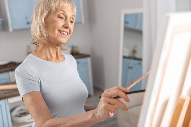 Gay mature woman drawing painting - 写真・画像