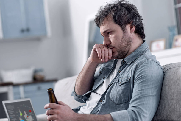 Divorced man drinking alcohol while thinking about his miserable life - Foto, immagini