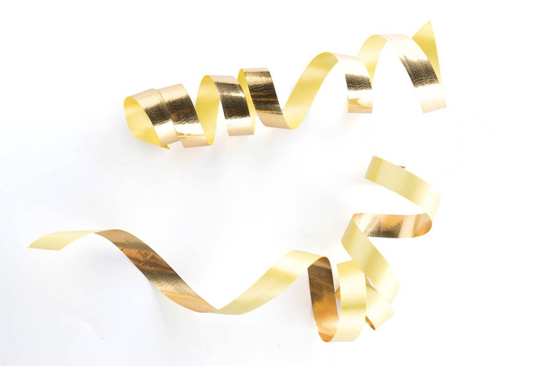 Golden ribbon roll isolated on white - Fotó, kép