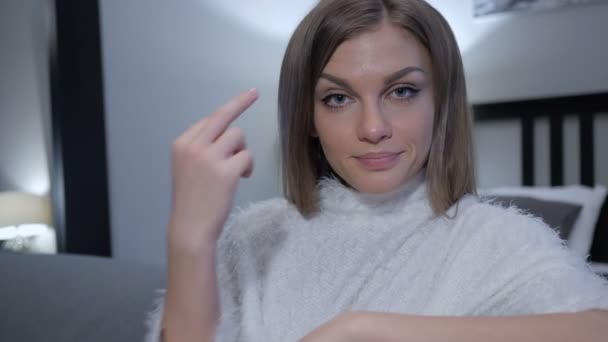 Middle Finger by Casually Sitting Woman, Close up - Materiał filmowy, wideo