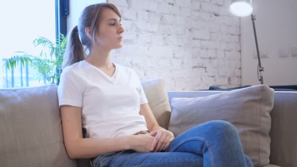 Casual Woman Sitting on Couch in Office - Materiał filmowy, wideo
