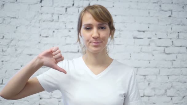 Slow Motion of Thumbs Down by Young Woman - Footage, Video