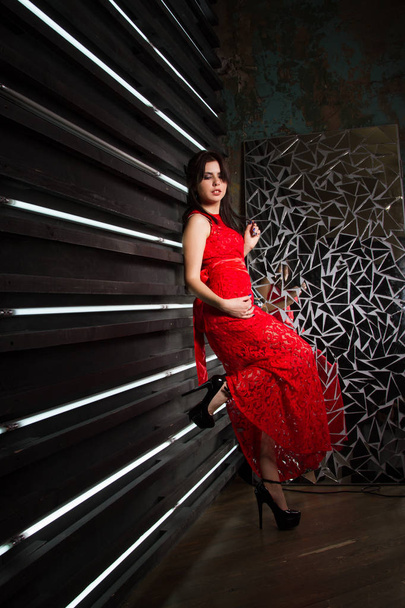 Girl in a long red dress. Studio portrait. - Foto, Imagem