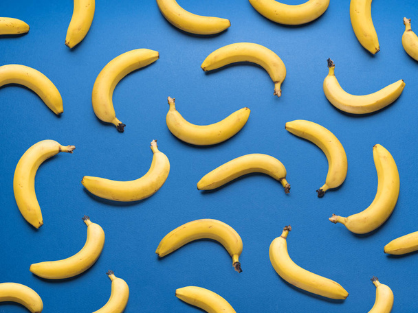 Bananas on the blue background. - Zdjęcie, obraz