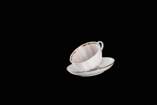 white cup and plate isolated on black - Photo, Image