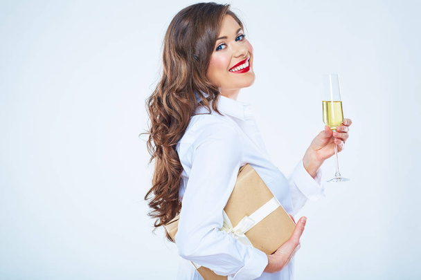 Toothy smiling woman with red lips holding gift box and vine gla - Fotografie, Obrázek