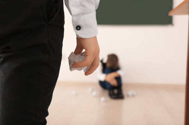 Little boy bullying his classmate in school - Valokuva, kuva