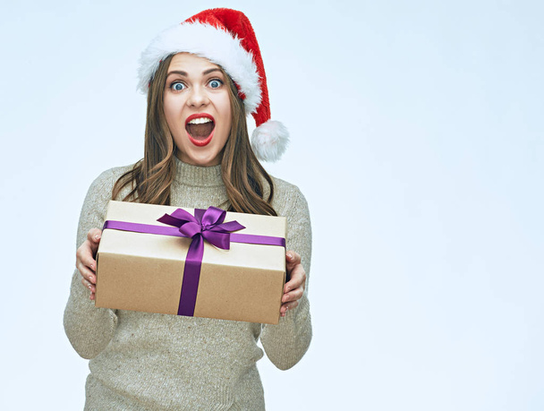 Beautiful surprised woman in santa hat holding gift box, new year concept - Fotografie, Obrázek