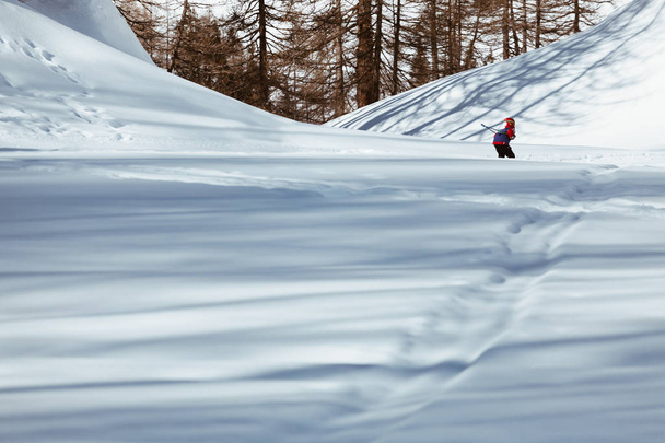 Kid skier skiing down the slope - downhill in high mountains - Photo, Image