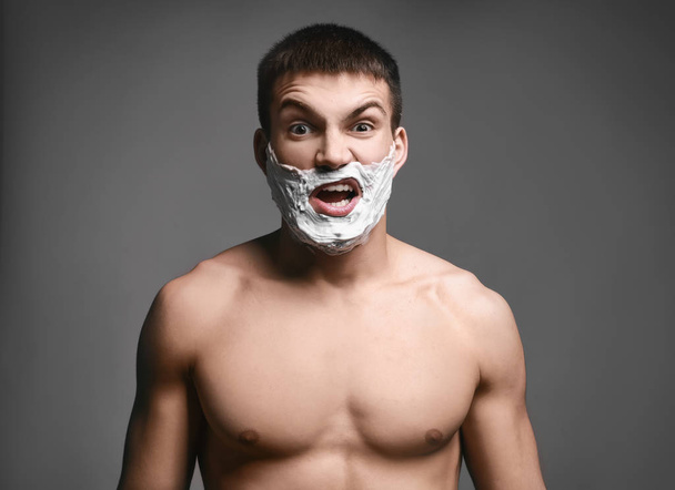 young man with shaving foam - Foto, Bild