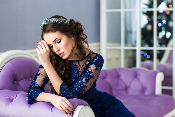 Fashion portrait of a beautiful young woman with a blue jewelry - Valokuva, kuva