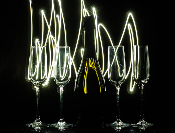 Glasses of champagne on bright background with bokeh effect. Cheers - Фото, изображение