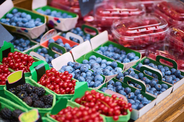 Closeup of boxes with colorful raw berries in fruits shop - Photo, Image