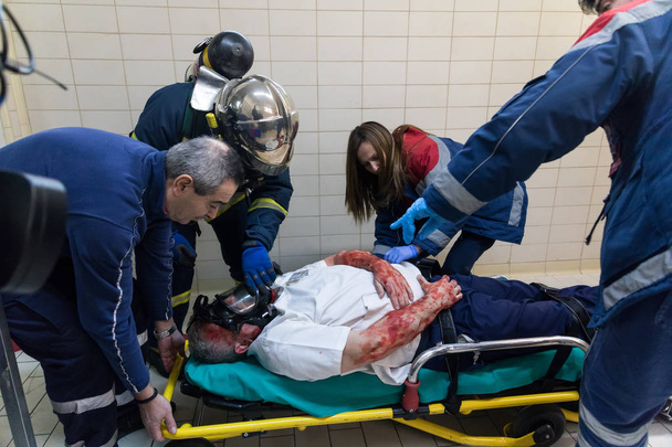 Salvation crews evacuate patients and injured in hospital AXEPA  - 写真・画像