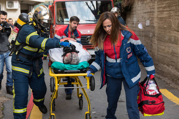 Salvation crews evacuate patients and injured in hospital AXEPA  - Фото, зображення