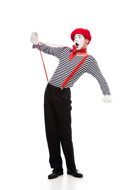 shocked mime looking at red suspenders isolated on white - Photo, Image