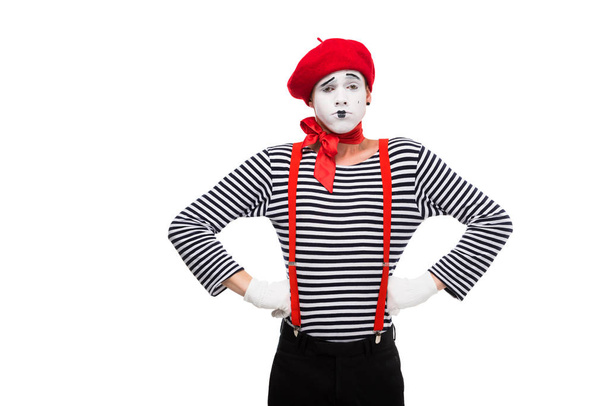 grimacing mime standing with hands akimbo isolated on white - Photo, Image