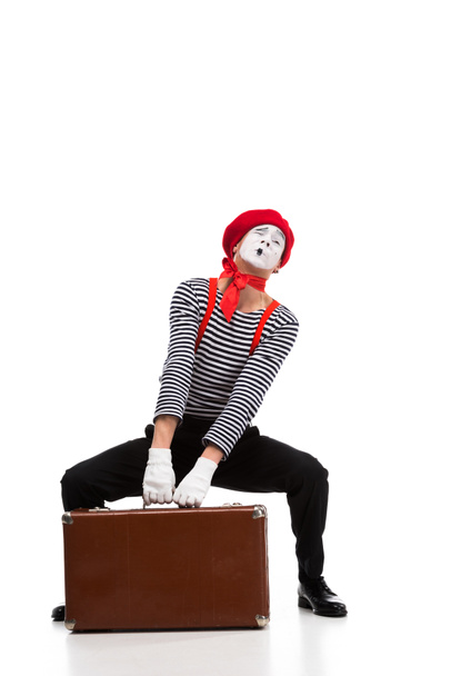 mime lifting up heavy brown suitcase isolated on white - Foto, immagini