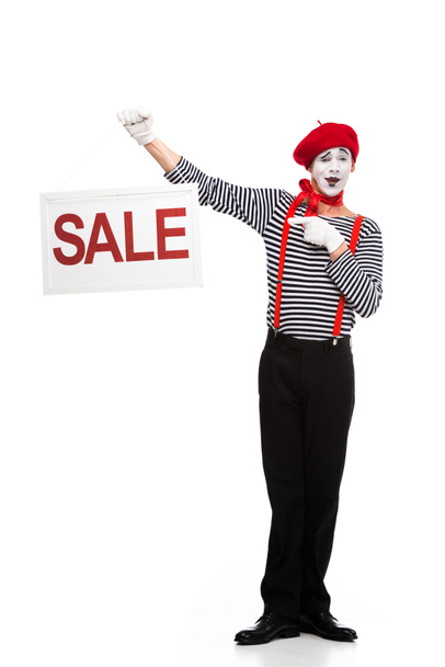 happy mime pointing on sale signboard isolated on white - Photo, Image