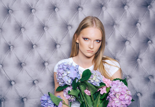 Girl with blond hair, makeup face hold hortensia - 写真・画像