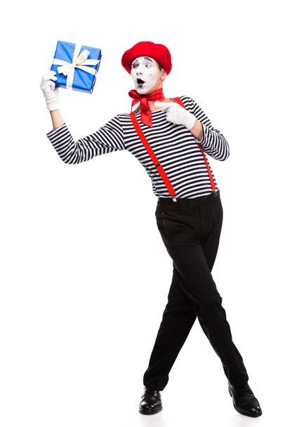 surprised mime pointing on gift box isolated on white - Photo, Image
