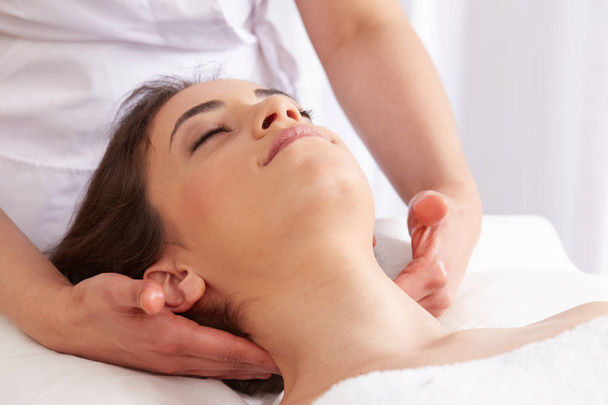 Female Enjoying Relaxing face Massage In Cosmetology Spa Center - Foto, imagen