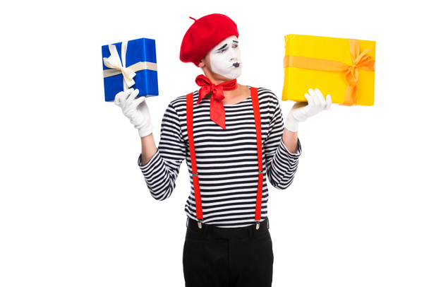 grimacing mime holding gift boxes isolated on white - Photo, Image