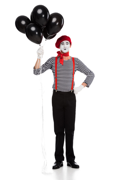 cheerful mime holding bundle of black balloons with helium isolated on white - Photo, Image